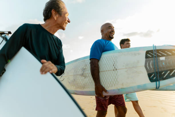 istock Surfer friends talking on the beach 2180287877