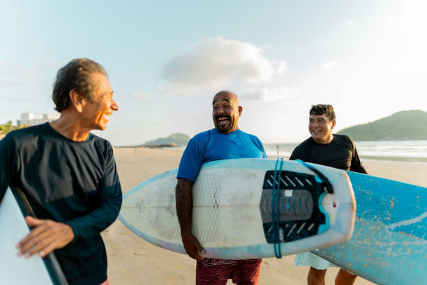 istock Surfer friends talking on the beach 2180287878