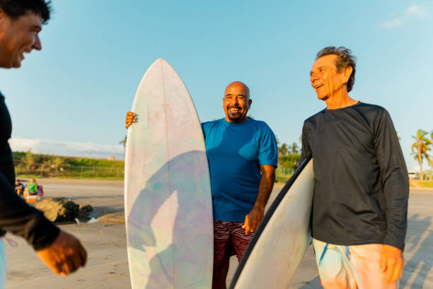 istock Surfer friends talking on the beach 2180287888