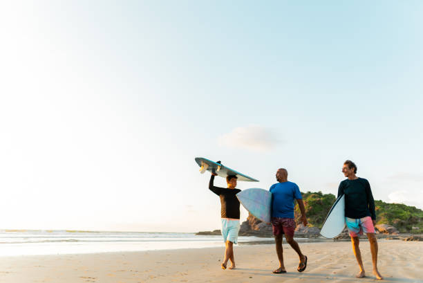 istock Surfer friends talking on the beach 2180287922
