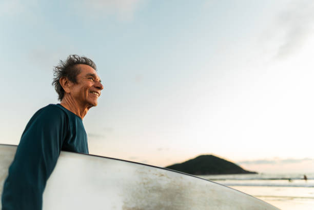 istock Senior surfer man contemplating on the beach 2180287984