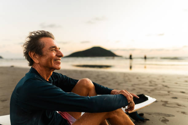 istock Senior surfer man contemplating on the beach 2180288005