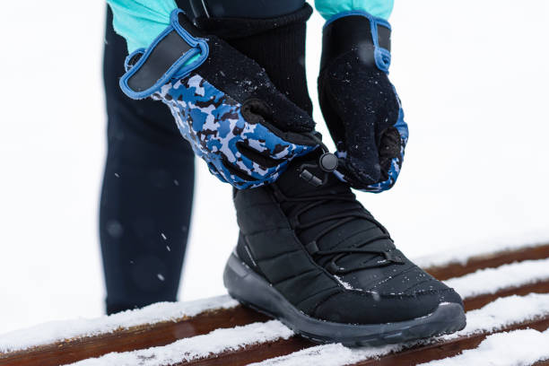 istock runner laces up shoes before running 2180288023