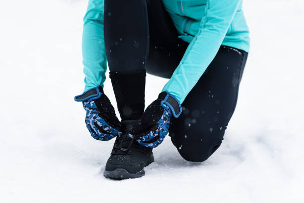 istock runner laces up shoes before running 2180288047