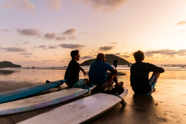 istock Surfer friends talking on the beach 2180288081