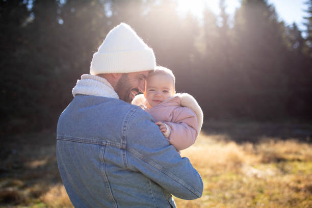 A single father with a baby enjoys nature
