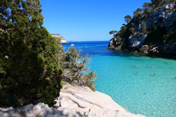 istock Panoramic view of the beaches of Macarella and Macarelleta. This remote bay has high cliffs covered in pine-trees which drop down to pale white sand and crystal-clear water. Paradisiacal beaches with turquoise waters. Island of Menorca. Balearic Islands 2180296153