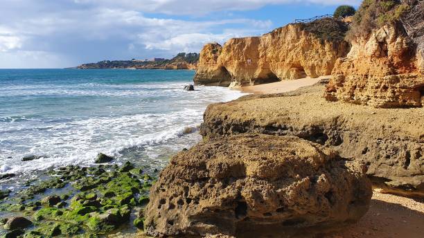 istock Algarve coastline with cliffs and ocean waves. 2180297197