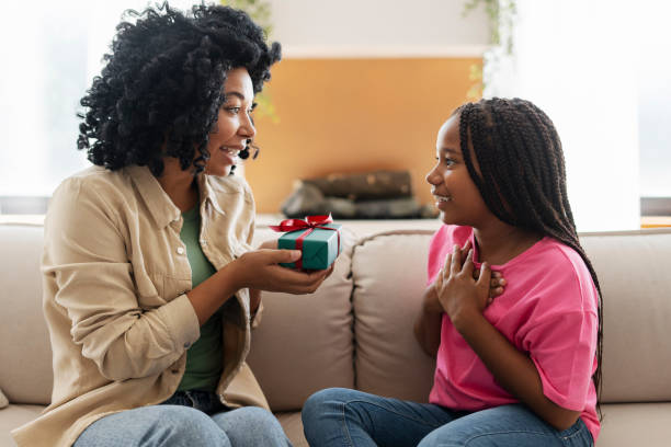 istock Happy mother giving a present to her excited daughter 2180298521