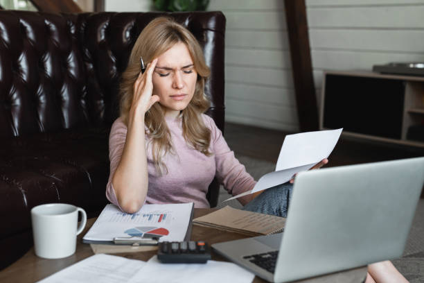 istock Caucasian woman female freelancer manager having headache migraine while working remotely on laptop computer at home, calculating monthly expenses, mortgage payments, having financial problems. 2180301013