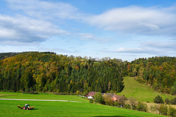 A tractor cuts hay on a field,lower austria,Austria
