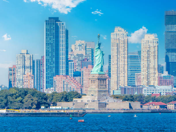 istock Statue of Liberty with some skyscrapers on the background 2180303547