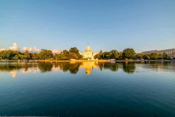 istock United States Capitol reflected on the pool at sunset 2180303628