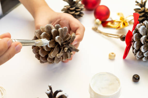 istock A child makes Christmas decorations with his own hands. 2180304524
