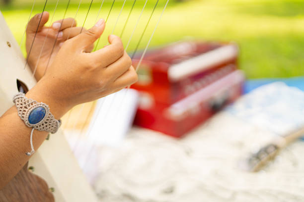 A Japanese female harpist is playing harp in a garden.
