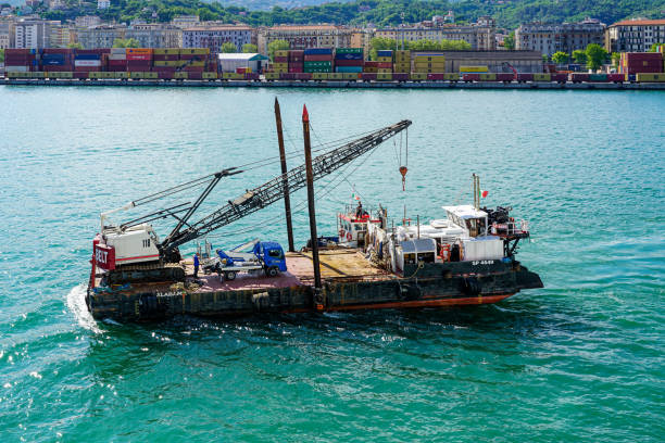 La Spezia, Italy - May 28, 2024: Pontoon Alabama SP 4649, a mobile workshop with ramps for loading wheeled and crawler machine floats in the seaport