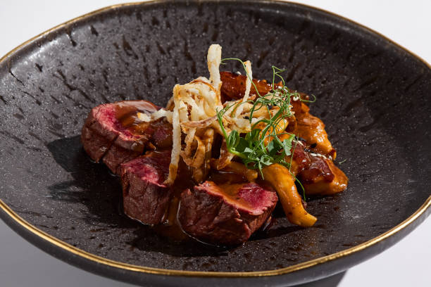 istock Gourmet Beef Tenderloin with Mushroom Sauce in Dramatic Lighting 2180306029