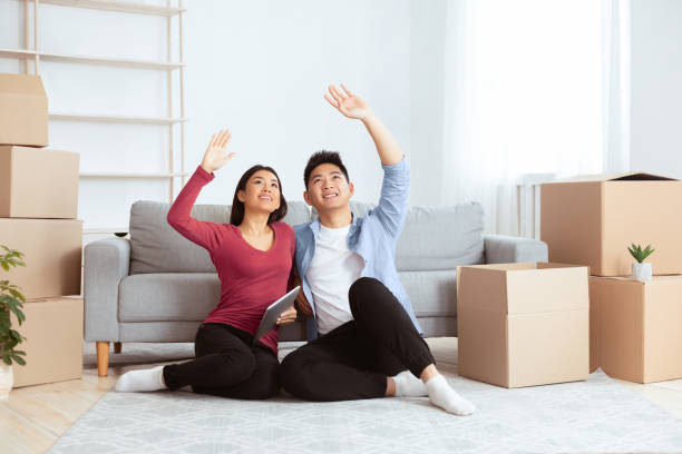 istock Asian couple discussing design of their new flat 2180307980