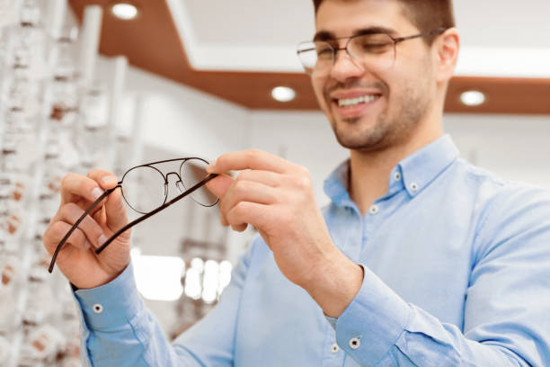 istock Portrait of handsome young guy choosing spectacles 2180309037