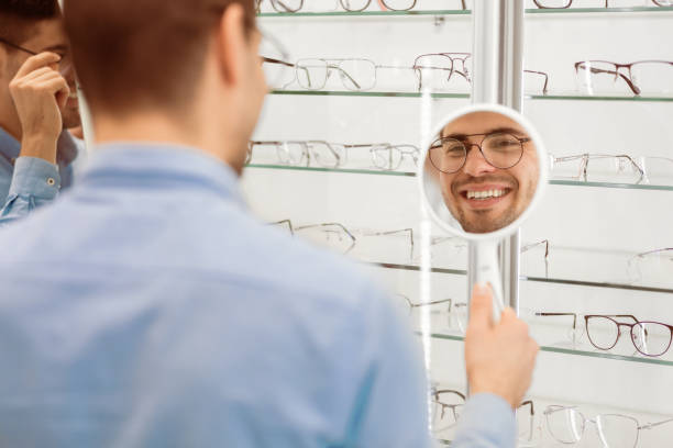 istock Happy man choosing glasses at optics store 2180309045