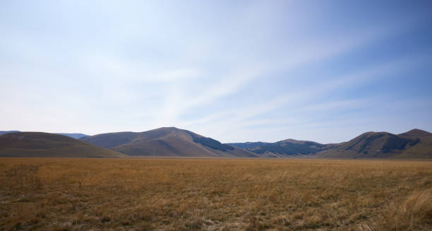 istock Beautiful Castelluccio's grasslands and mountains under sky 2180309064