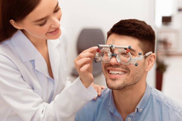 istock Optometrist checking patients vision with trial frame at clinic 2180309085