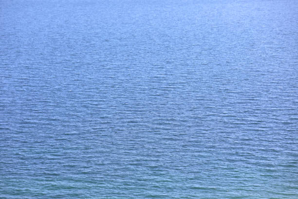 perfect marine background with deep blue sea water and very few low waves