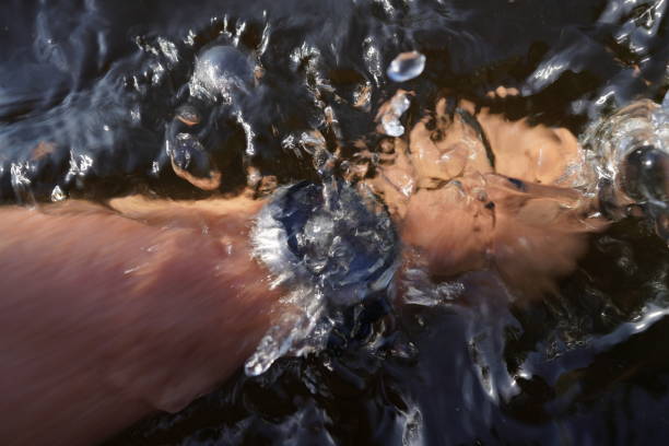 Swimming Watch. Smartwatch for swimming training. Watersport with sports watch. Multi-sport with smartwatch. Watch for Watersports. Waterproof Watch on hand of swimmer. Swim Smartwatch underwater.