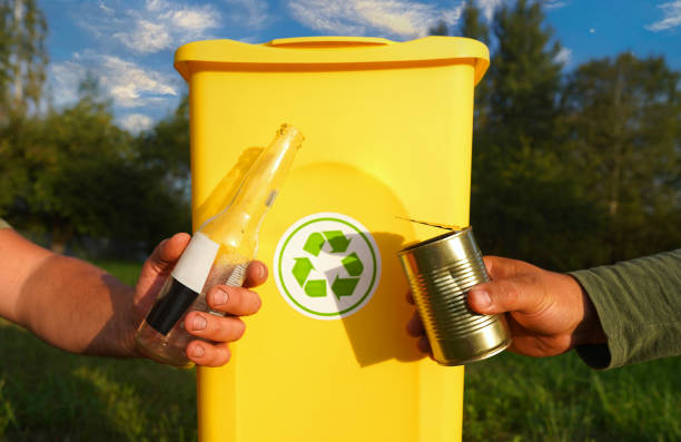 istock Waste sorting for Recycling. Empty glass bottles in trash bin container. Glass bottles collection for Recycling. 2180312623