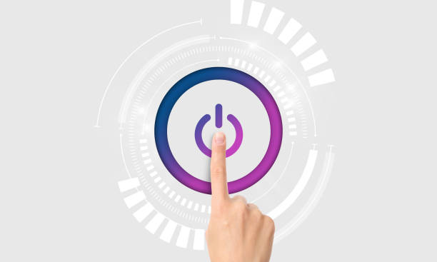Hand pressing giant power button isolated on grey background. Turning on machine, system online activation.