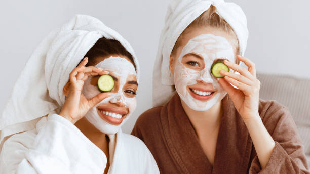 istock Panoramic photo of smiling girlfriends making face care procedures 2180314433