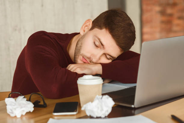 istock Exhausted Man Sleeping At Laptop Sitting In Office 2180316193