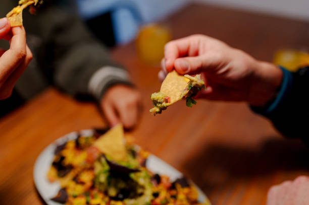 istock People eating Mexican nachos 2180320531