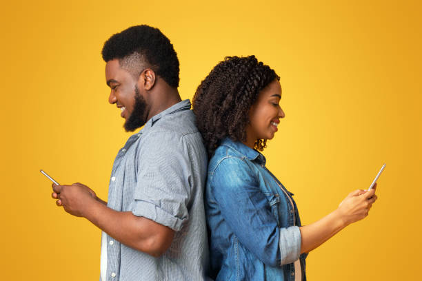 istock Black Couple Using Smartphones, Standing Back To Back Ignoring Each Other 2180322665