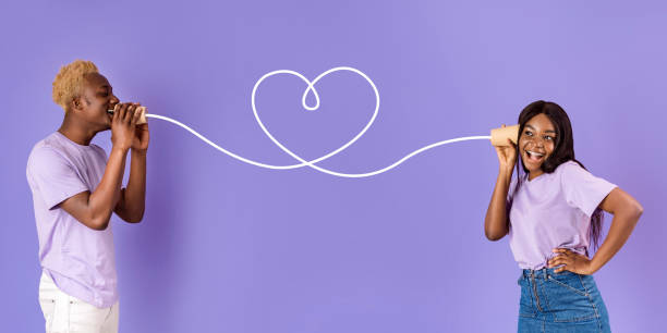 istock African American guy sharing feelings with his girlfriend through tin can phone on lilac background 2180322739