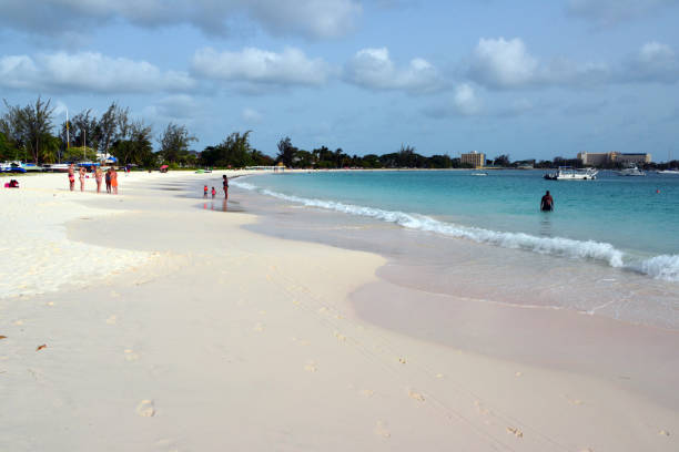 Bridgetown, Barbados: Brownes Beach, stretching along the picturesque Carlisle Bay, south of Bridgetown, is one of Barbados' most popular and accessible public beaches. This long expanse of pristine white sand is known for its calm, crystal-clear waters that are perfect for swimming and snorkeling, with several shipwrecks lying beneath the surface that attract both marine life and diving enthusiasts. The beach offers excellent facilities including parking, beach chair rentals, and various food vendors selling local specialties, while its location near the capital city makes it a favorite spot for both locals and tourists. The waters are typically gentle and shallow near the shore, making it ideal for families with children, and its western orientation provides spectacular sunset views over the Caribbean Sea.