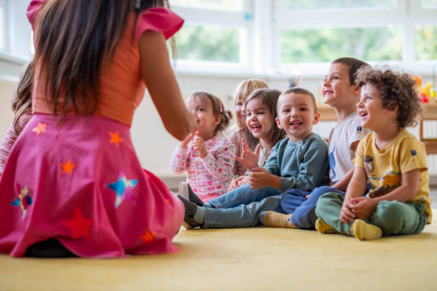 istock obedient children sit happily while the crying girl shows them something 2180323385
