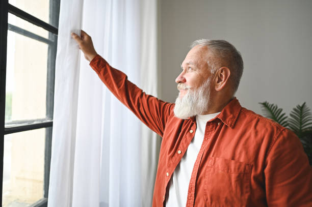 istock happy senior man at home 2180329404