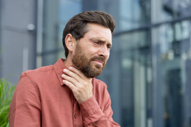 istock A man with a red shirt and a beard is sitting on a bench 2180329498