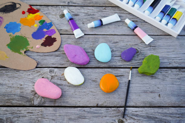 istock Flat stones painted with acrylic paints. Do it yourself. Souvenirs that children can make. 2180333337