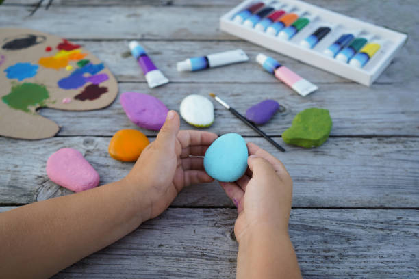 istock Flat stones painted with acrylic paints. Do it yourself. Souvenirs that children can make. 2180333359