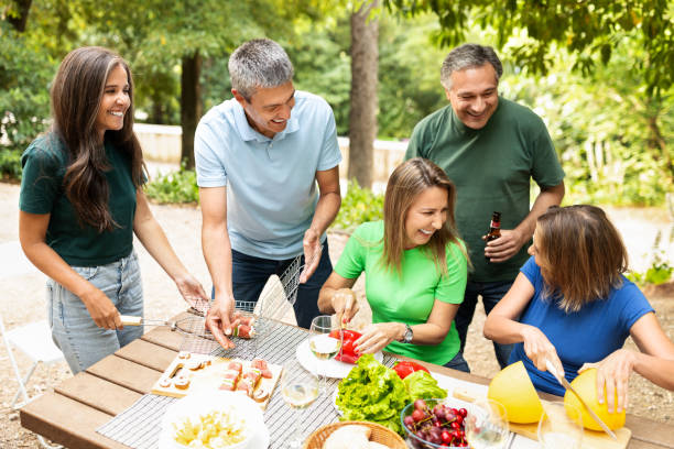 istock Friends enjoying a summer barbecue gathering in a lush outdoor setting 2180337632