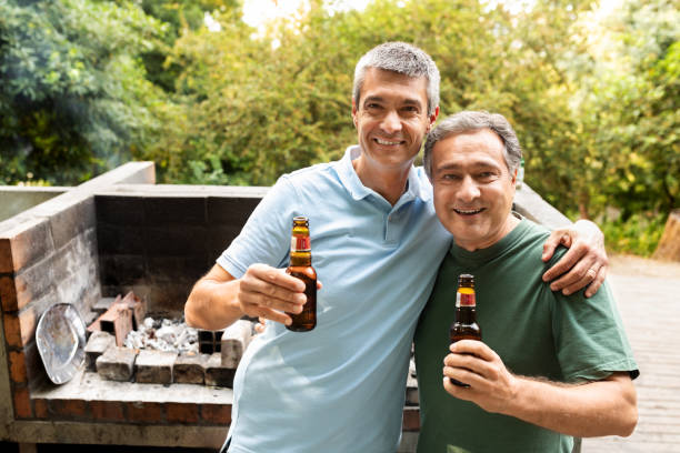 istock Friends enjoying a barbecue with drinks in a lush garden during summer 2180337640