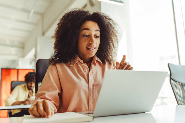 istock Young manager woman explaining during online meeting in modern office 2180338151
