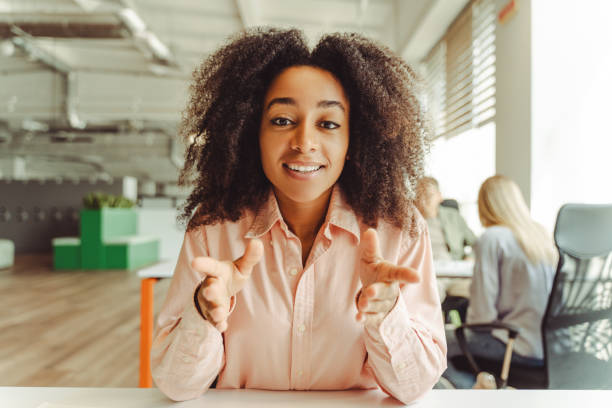 istock Young manager woman making video call gesturing talking looking at camera in office 2180338159