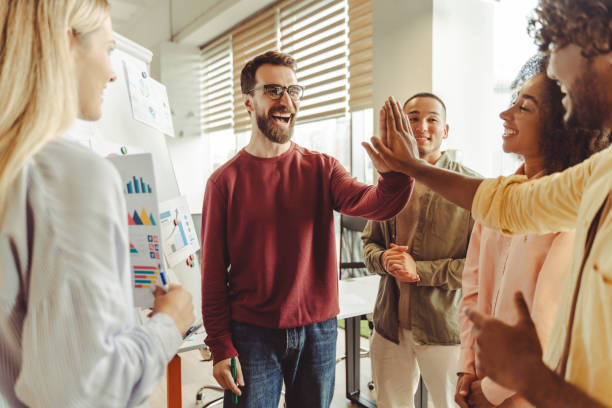 istock Diverse business team giving high five after successful presentation 2180338203