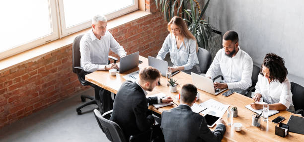 istock Diverse Colleagues Working Sitting Together In Modern Office, High-Angle Shot 2180340678