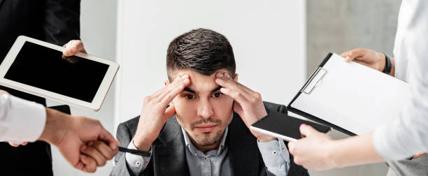 istock Stressed Businessman Tired Of Tasks Sitting At Work In Office 2180340763