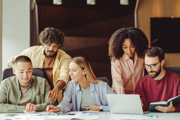 istock Diverse team of young professionals collaborating on a project in a modern office 2180342474