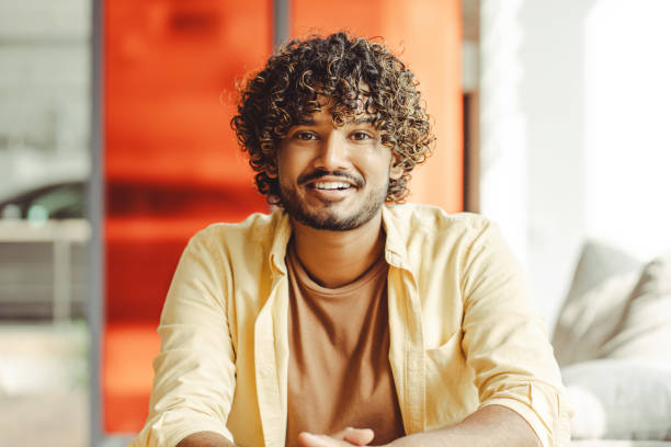 istock Portrait of young indian freelancer smiling while working from home 2180342475